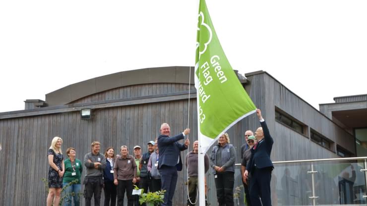 Andy Ansell Head of Estates hoists the Green Flag at the National Memorial Arboretum